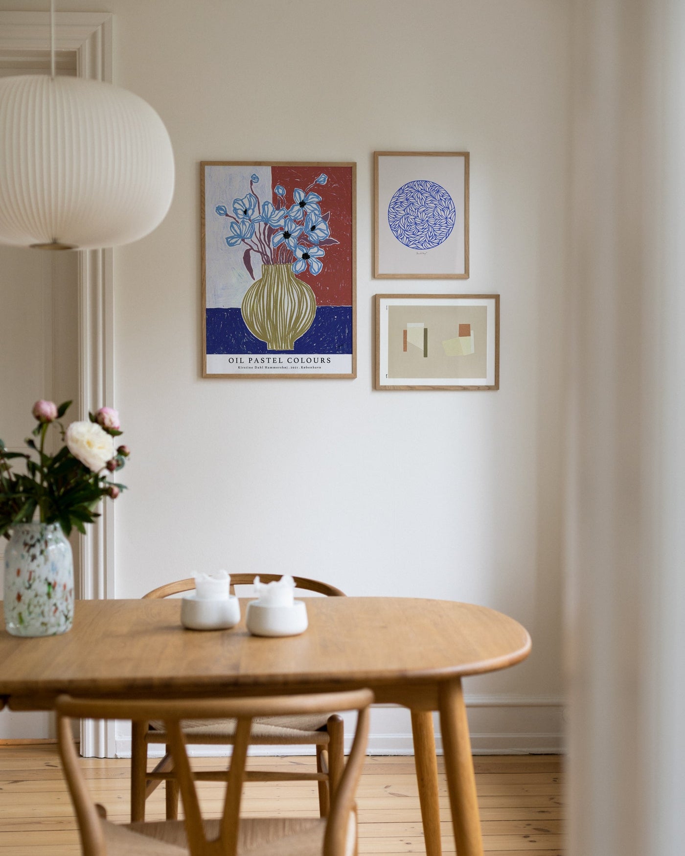 Colourful mix of art prints over the dining table
